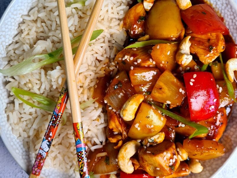 sweet and sour chicken,and rice with chopsticks