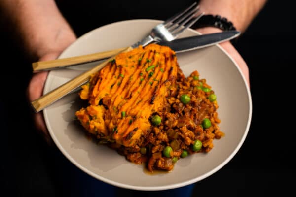 Chef holding plate of cottage pie