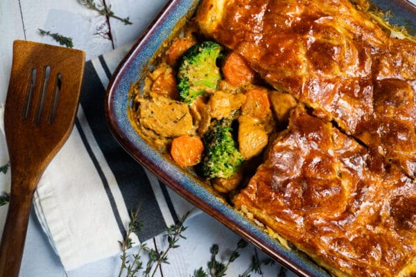 Top down image of Chicken and Broccoli pie with section cut out